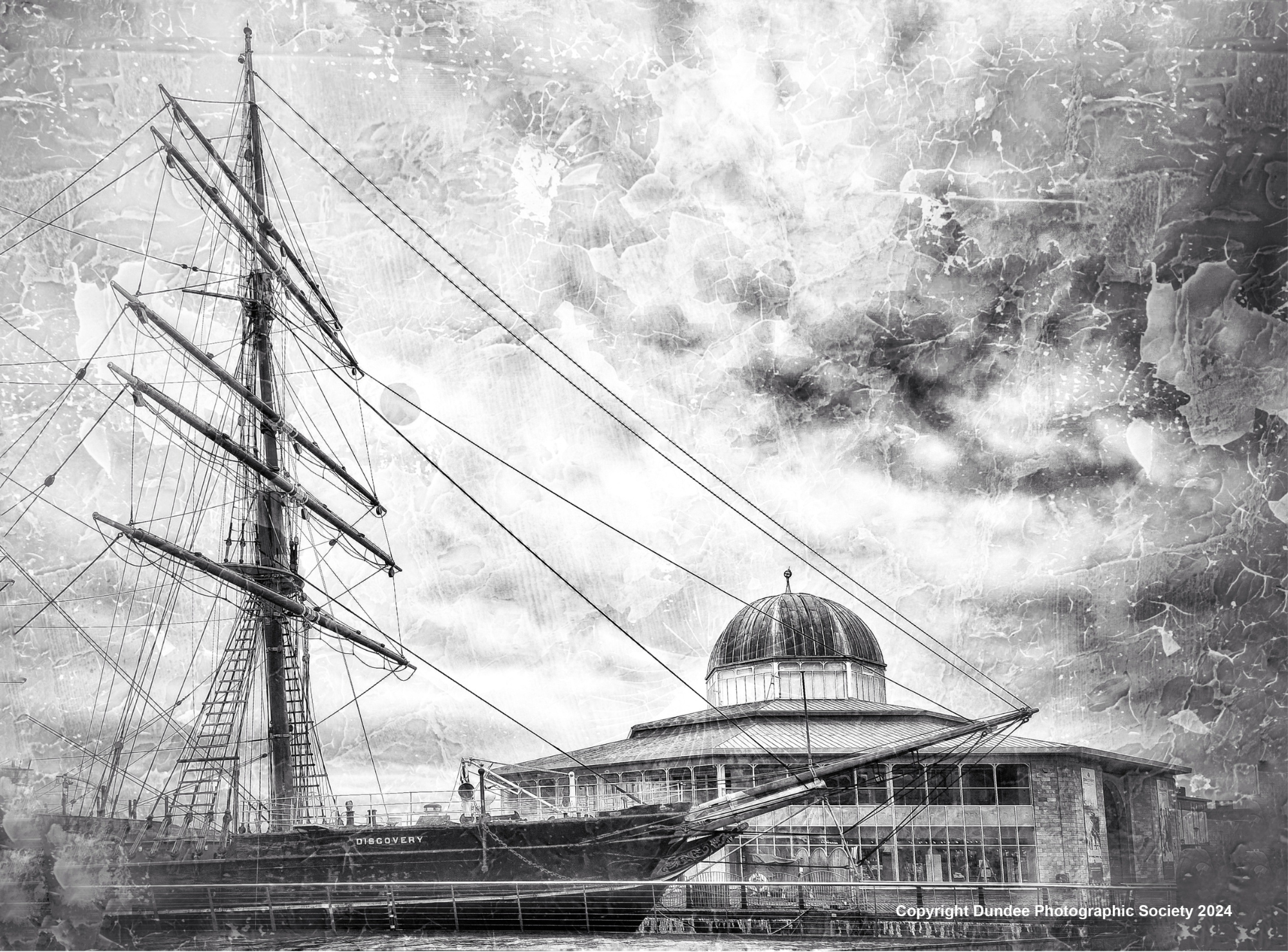 Black and white image of RRS Discovery and Discovery Point, by Dundee Photographic Society. High contrast clouds and sky seen above, with an overlay ripple filter.